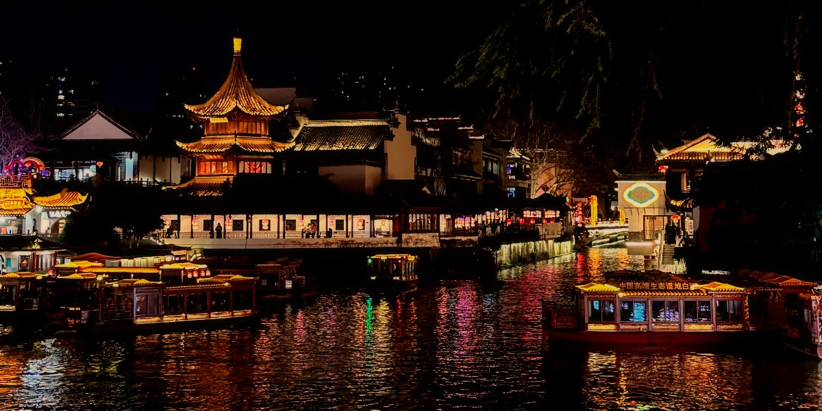 Qin Huai River side. Showing traditional buildings with the lights reflection in the dark.